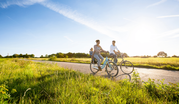 Young family cycling and enjoying the landscape